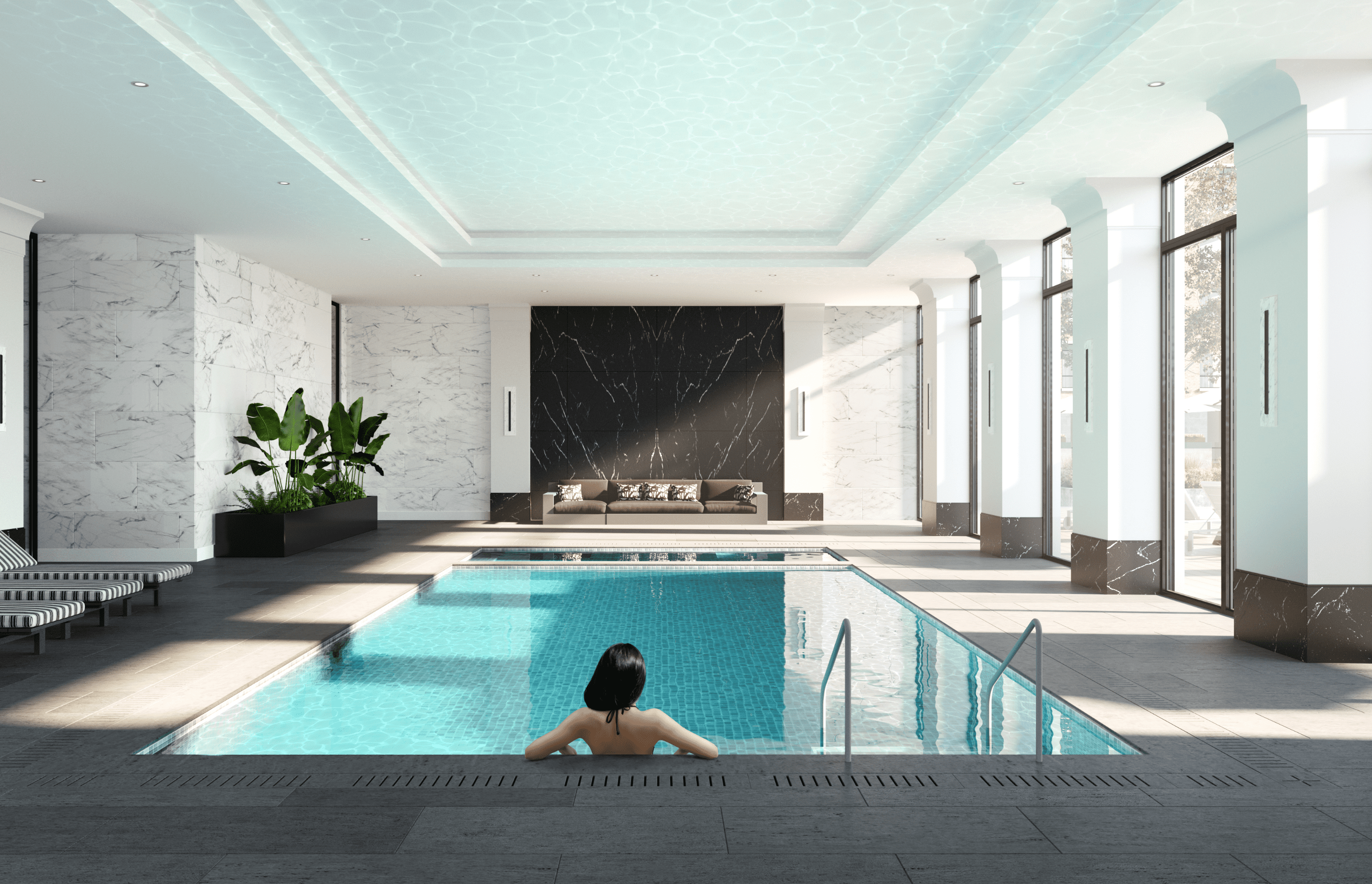 a woman swimming in a pool in a hotel lobby