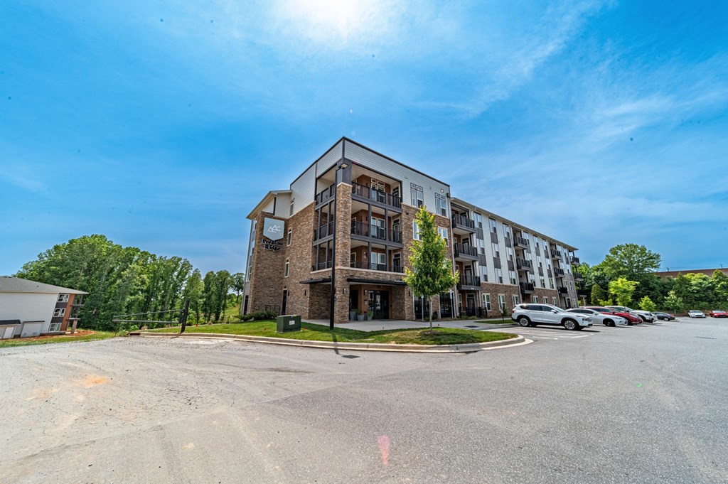 a large apartment building with a parking lot in front of it at Preston Ridge, Hickory, NC