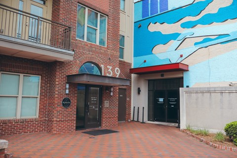 the entrance to a building with a mural on the side