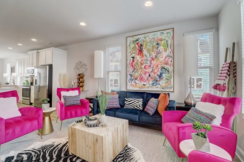 A living room with a large painting on the wall and a zebra print rug on the floor.