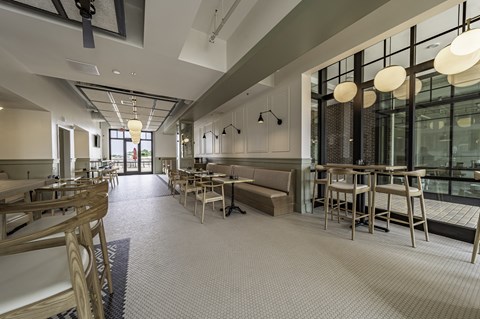 a rendering of a restaurant with a long communal table in the middle of the room