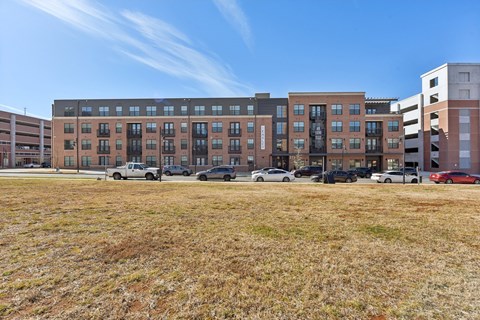 A parking lot with cars and a building in the background.