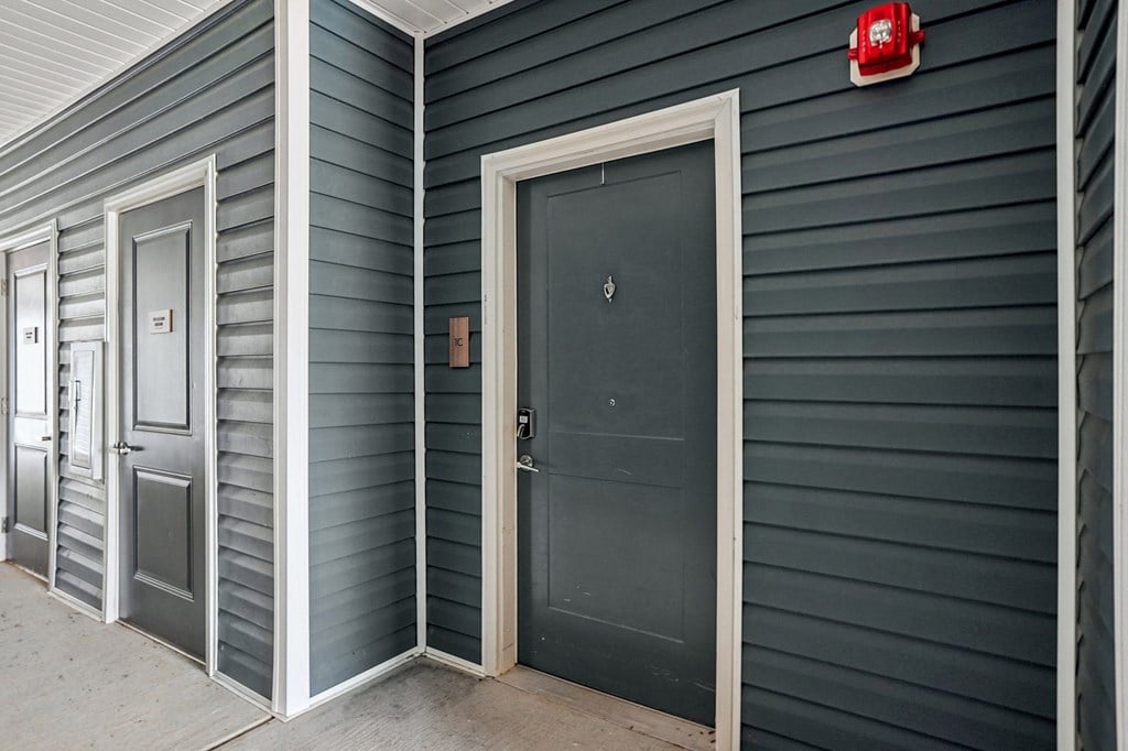 A series of doors with one being black and the others being grey.