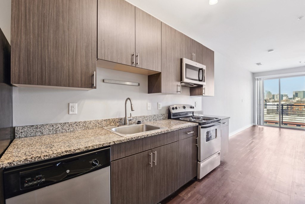 A kitchen with wooden cabinets and stainless steel appliances.