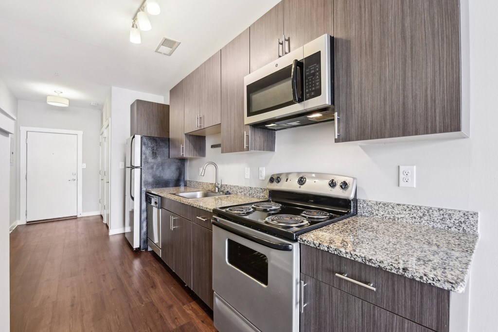A kitchen with a stove top oven and microwave.