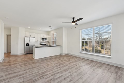 A spacious kitchen with a refrigerator, microwave, and oven.
