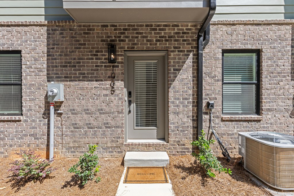 the front of a brick house with a door and a hot tub at The Collection Charlotte in Charlotte, NC, 28205