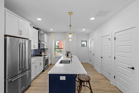 a large kitchen with white cabinets and stainless steel appliances at The Collection Charlotte in Charlotte, NC, 28205