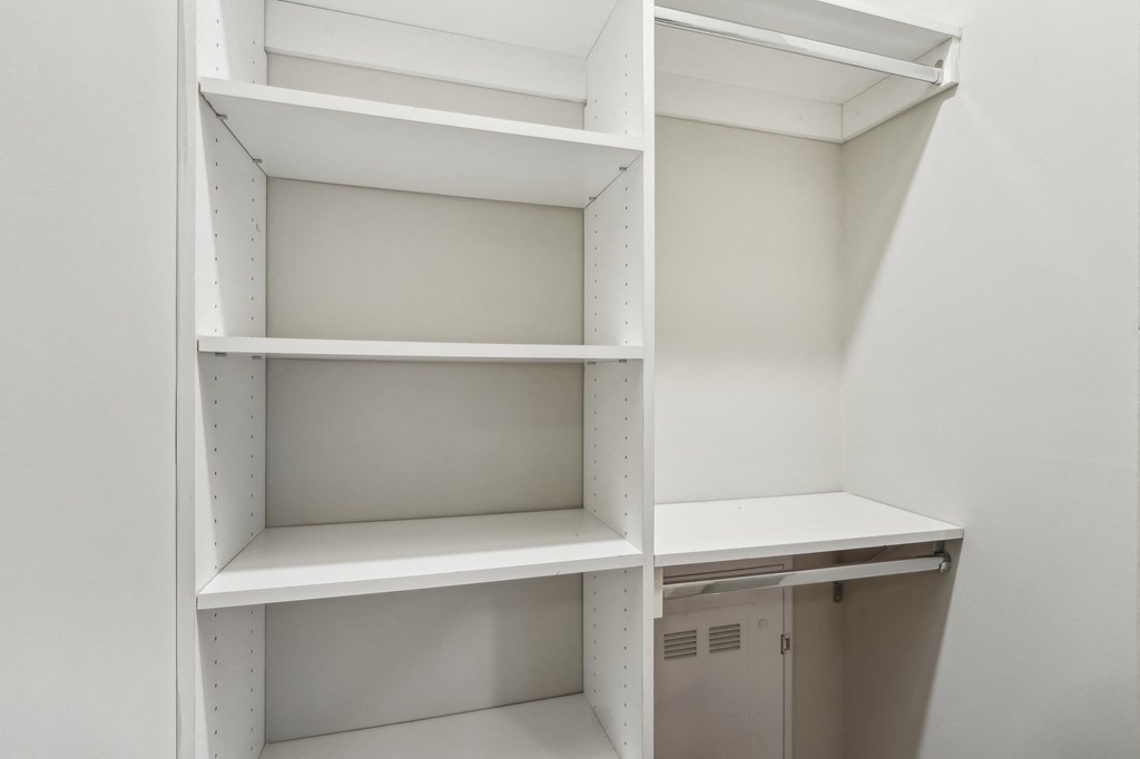 Empty white shelves in a room.