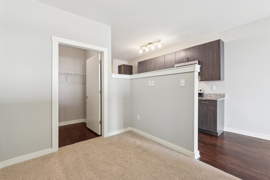 A room with a carpeted floor and a white door.