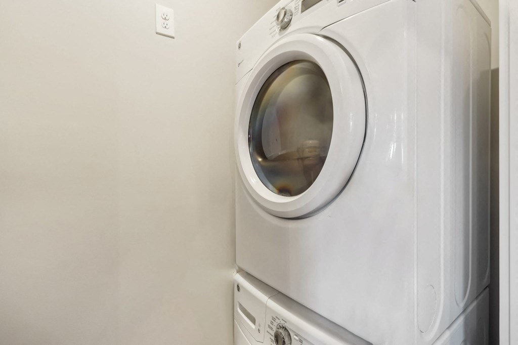 A white washing machine in a laundry room.