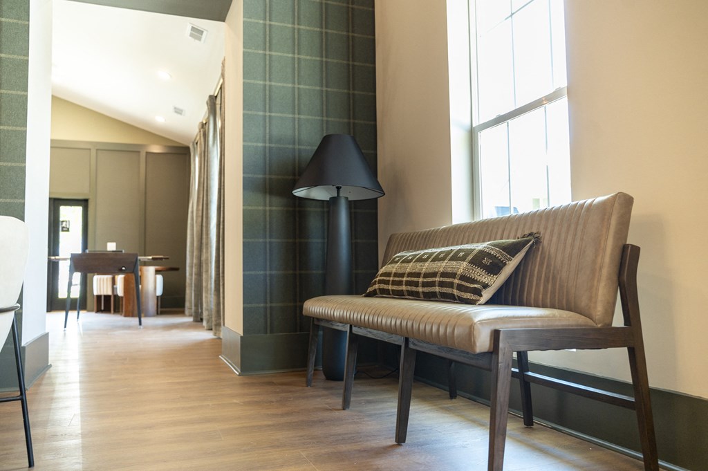 a seating area with a lamp and a table in the background at Landon Green Artisan Cottages Apartments, North Carolina, 28601
