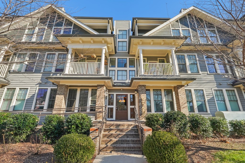 A large, two-story house with a front porch and multiple windows.