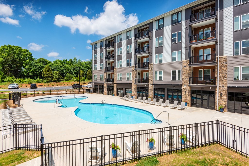 our apartments offer a swimming pool and a patio with chairs