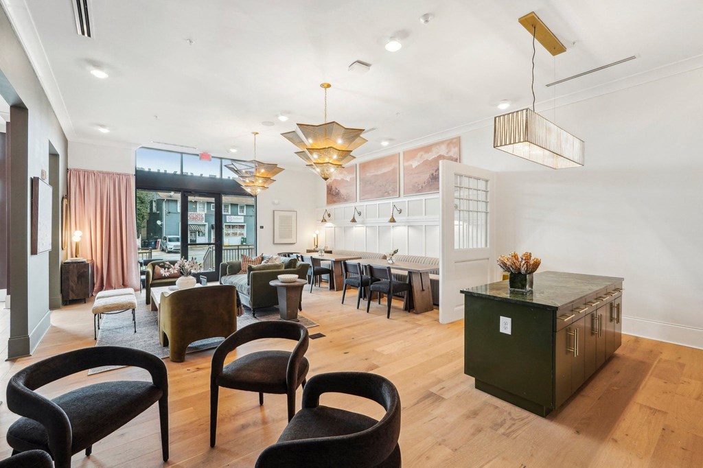 A room with a green cabinet and black chairs.