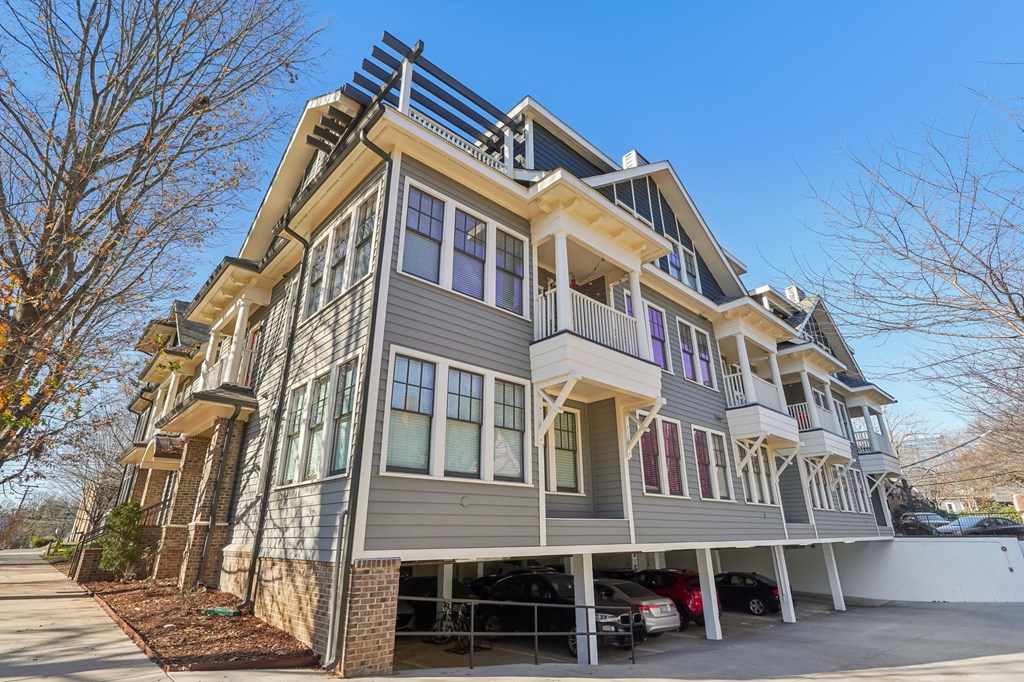 A modern two-story house with a balcony on the second floor.