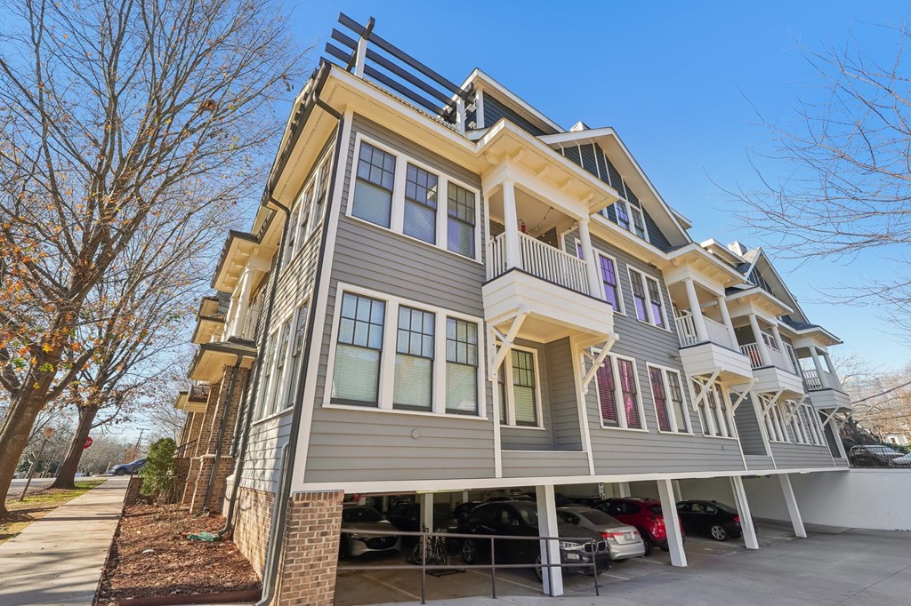 A modern two-story house with a balcony on the second floor.