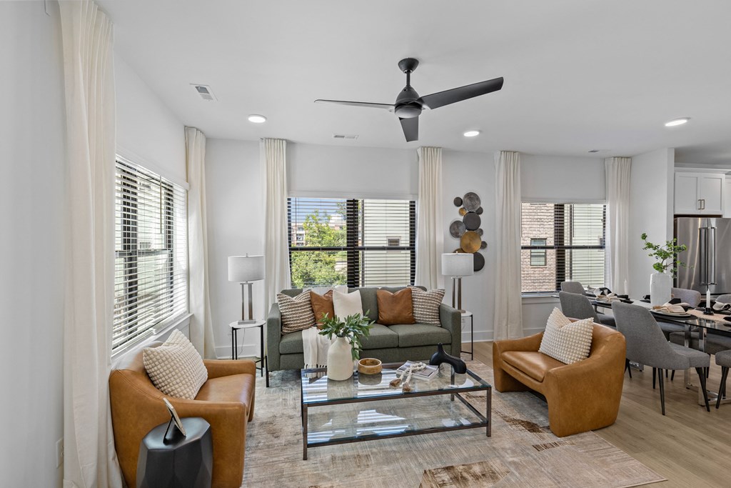 a living room with couches and chairs and a glass coffee table at The Collection Charlotte in Charlotte, NC, 28205