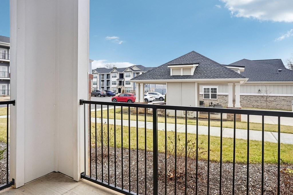 A white house with a black fence in front of it.