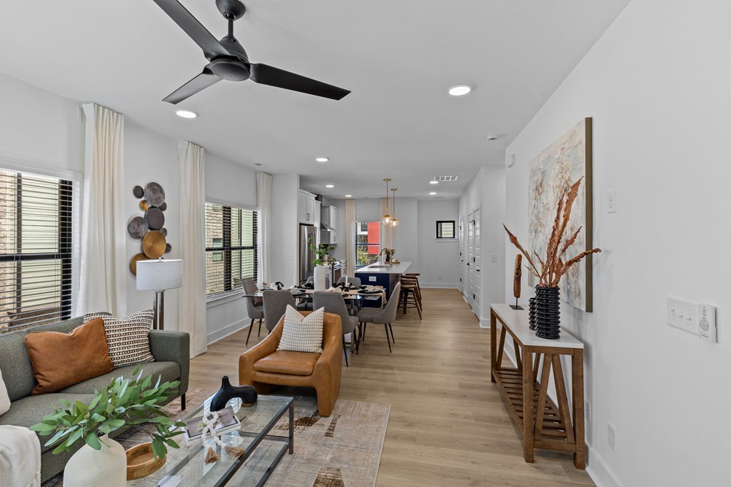 a living room and dining room with a ceiling fan at The Collection Charlotte in Charlotte, NC, 28205