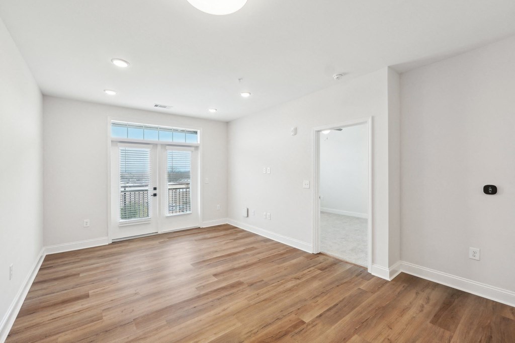 A room with wooden floors and white walls.