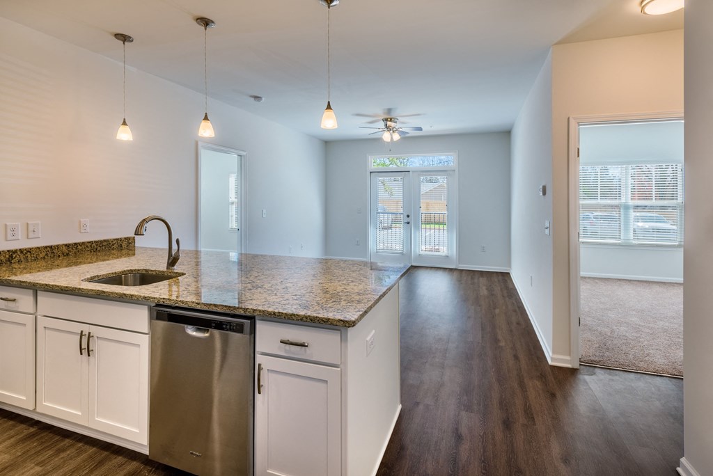 a kitchen with white cabinets and a granite counter top
