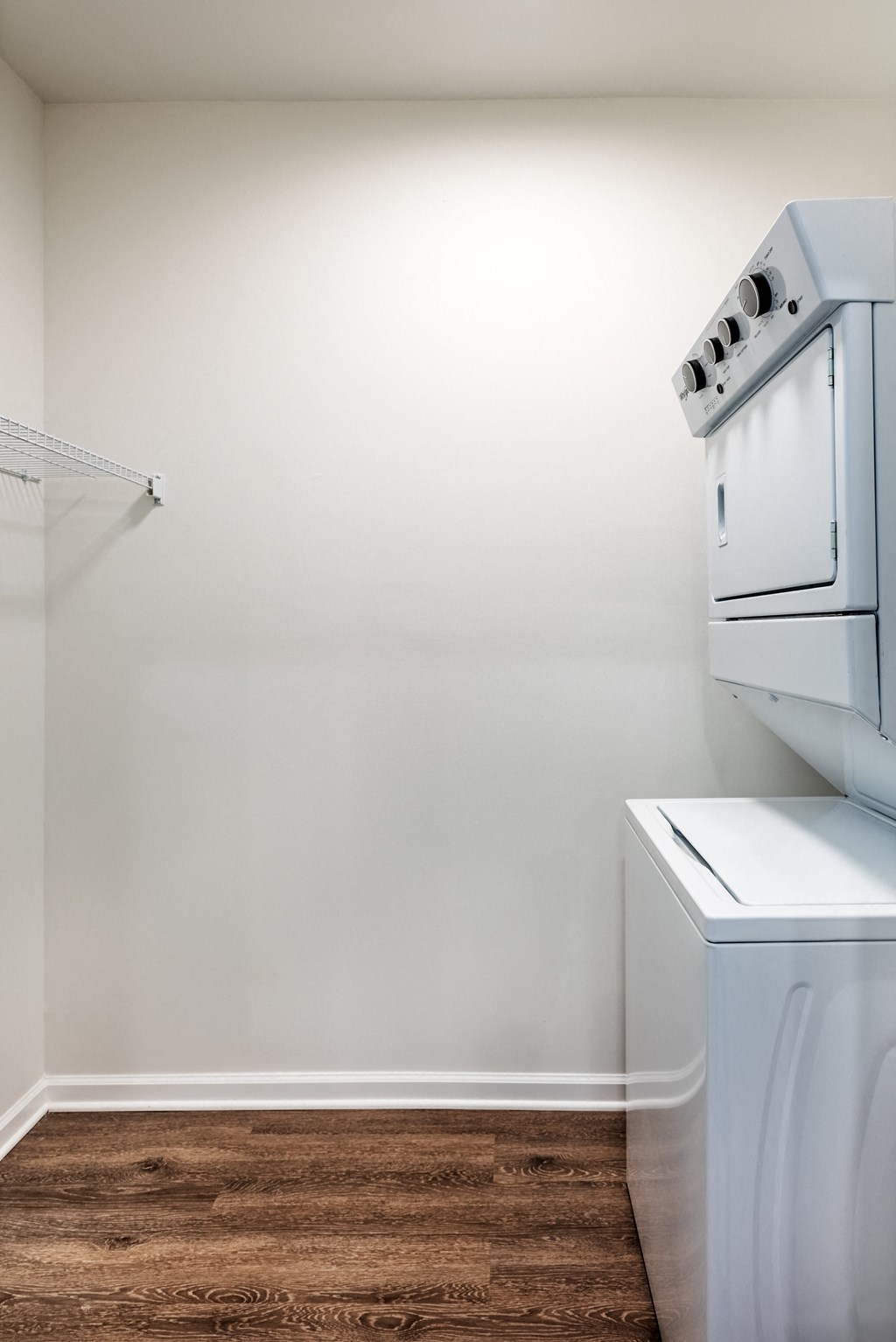 an empty laundry room with a washer and dryer in it