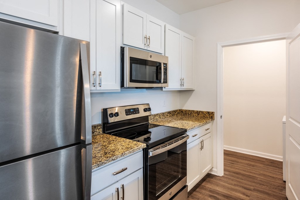 a kitchen with stainless steel appliances and white cabinets