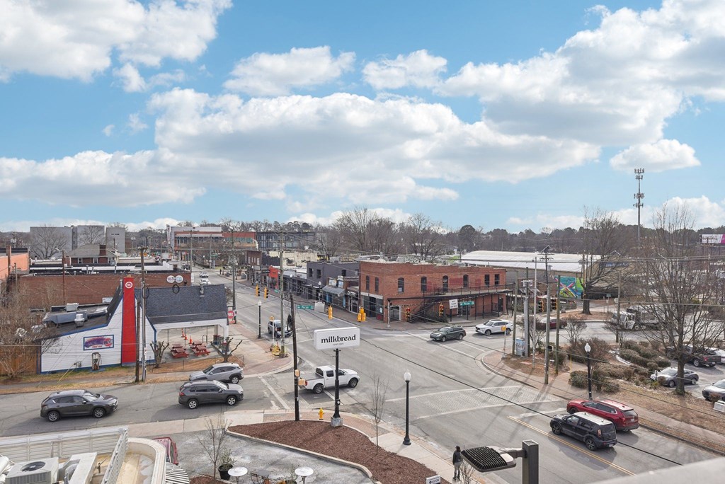 A view of a street with cars and buildings.