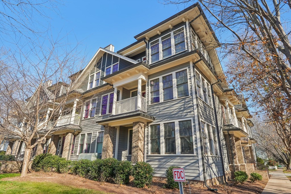 A two-story house with a balcony on the second floor.
