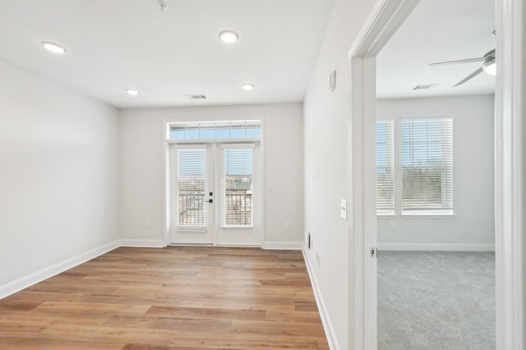A room with wooden floors and a sliding glass door.