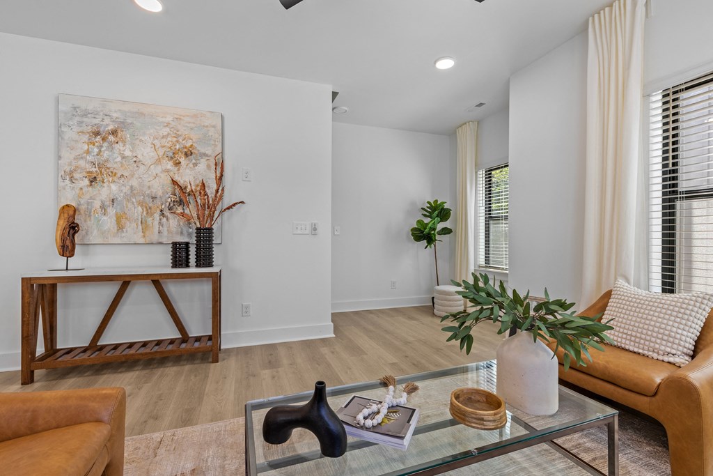 a living room with a couch and a glass coffee table at The Collection Charlotte in Charlotte, NC, 28205