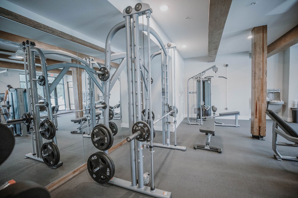 a fitness room with weights and other exercise equipment