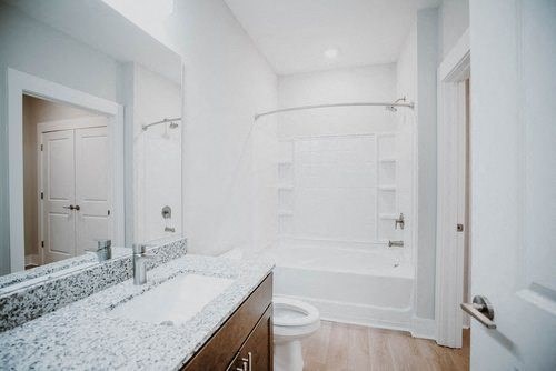 a bathroom with a sink and a shower and a toilet