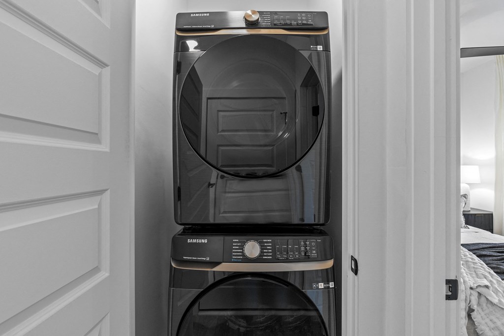 a washer and dryer stacked on top of each other in a small room at The Collection Charlotte in Charlotte, NC, 28205