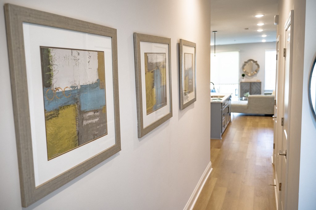 three pieces of art hanging on a wall in a home at Landon Green Artisan Cottages Apartments, Hickory, North Carolina