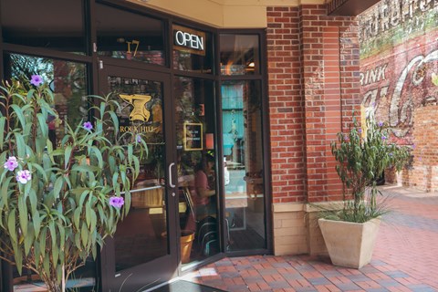 the front entrance of crave restaurant with glass doors