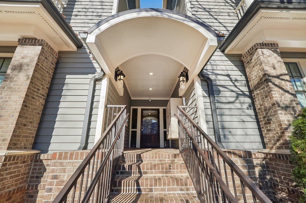 A house with a staircase leading to the front door.