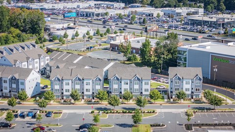 A view of a parking lot with a building that has the words "Extraspace" on it.