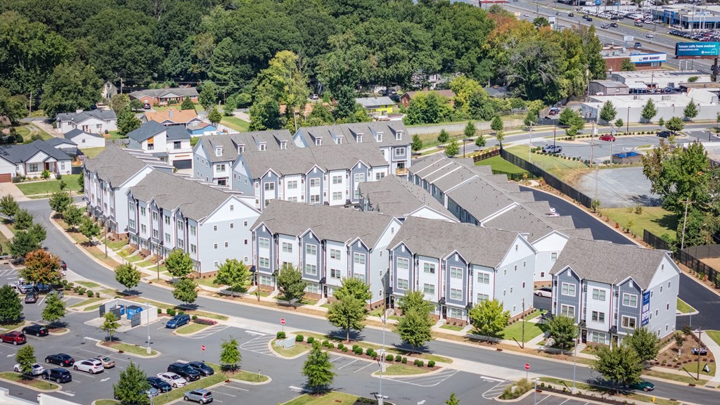 A large white building with a parking lot in front.