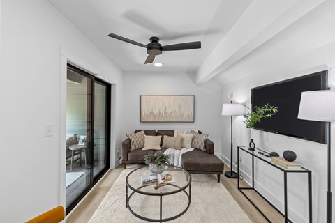 a living room with a couch and a ceiling fan
