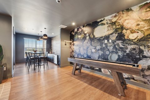 A room with a wooden floor and a large marble wall.