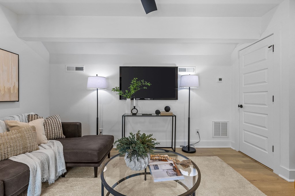 a living room with a couch and a coffee table and a television at The Collection Charlotte in Charlotte, NC, 28205