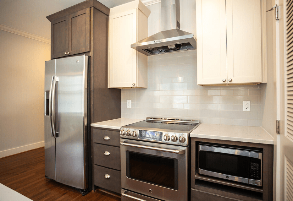 A modern kitchen with stainless steel appliances and wooden cabinets.