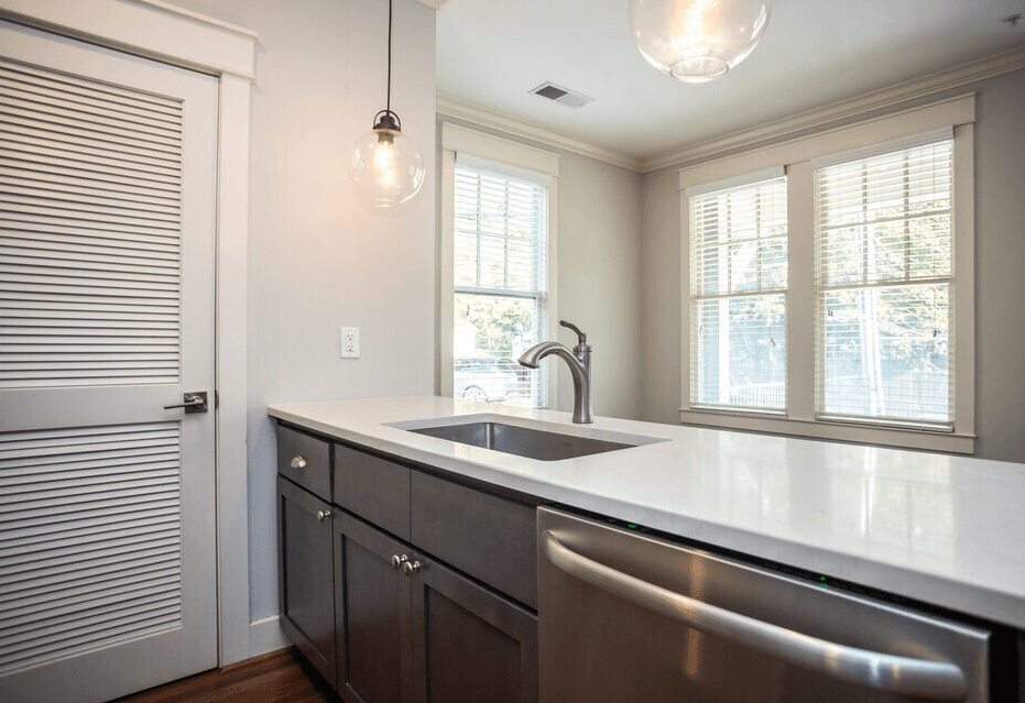 A kitchen with a sink and a window.