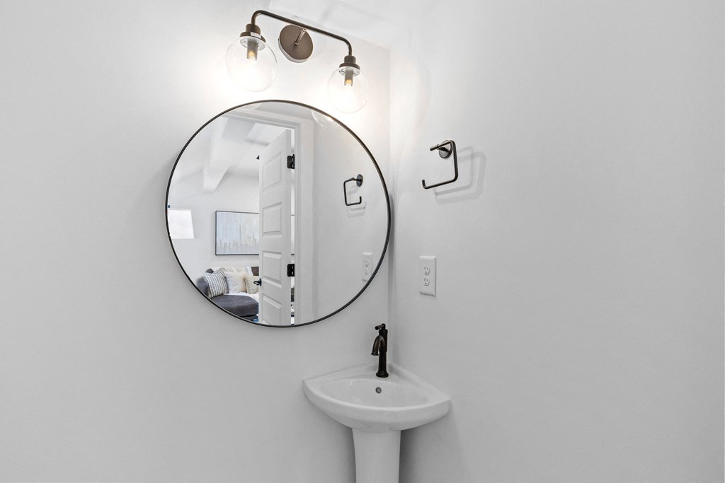 a white bathroom with a sink and a mirror at The Collection Charlotte in Charlotte, NC, 28205