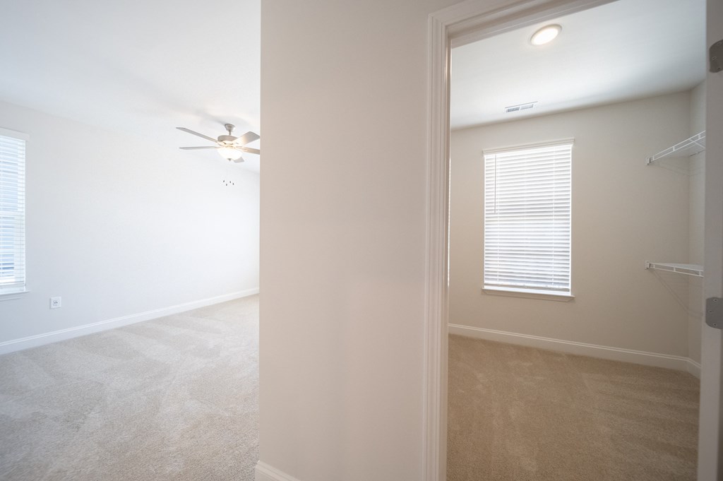 a bedroom with white walls and a ceiling fan at Landon Green Artisan Cottages Apartments, Hickory, NC, 28601