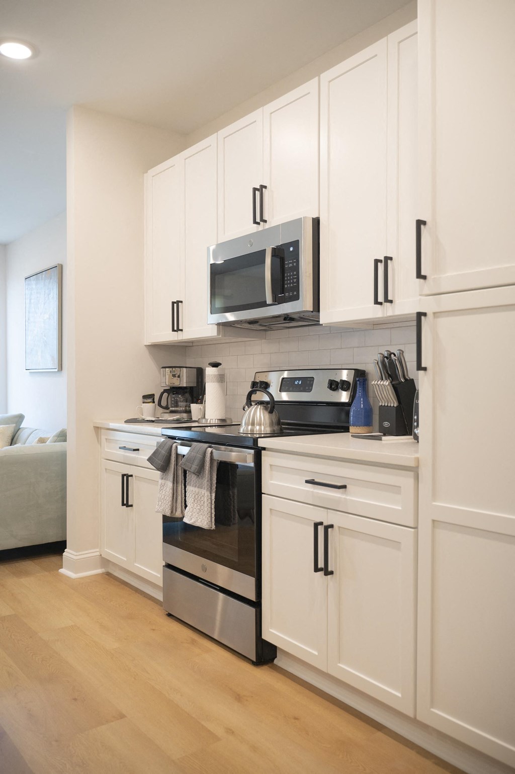 a kitchen with white cabinets and stainless steel appliances at Landon Green Artisan Cottages Apartments, Hickory, 28601