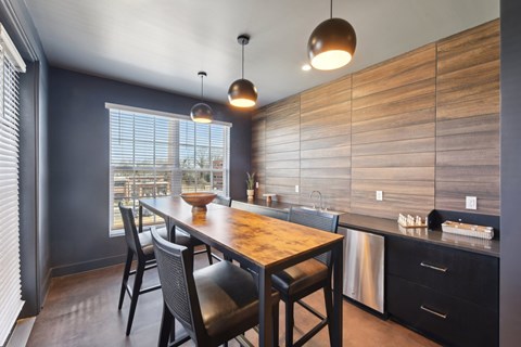 A kitchen with a wooden table and chairs.