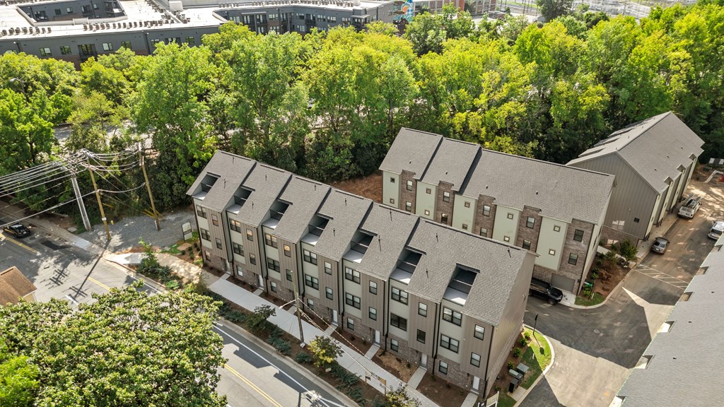 Apartment complex with grey roofs and multiple windows.